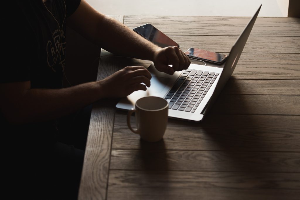 Marketing Individual using Macbook pro drinking coffee